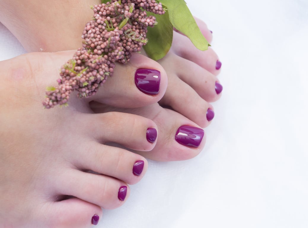 Women's feet with amazing pedicure. Nails with gel polish applied.